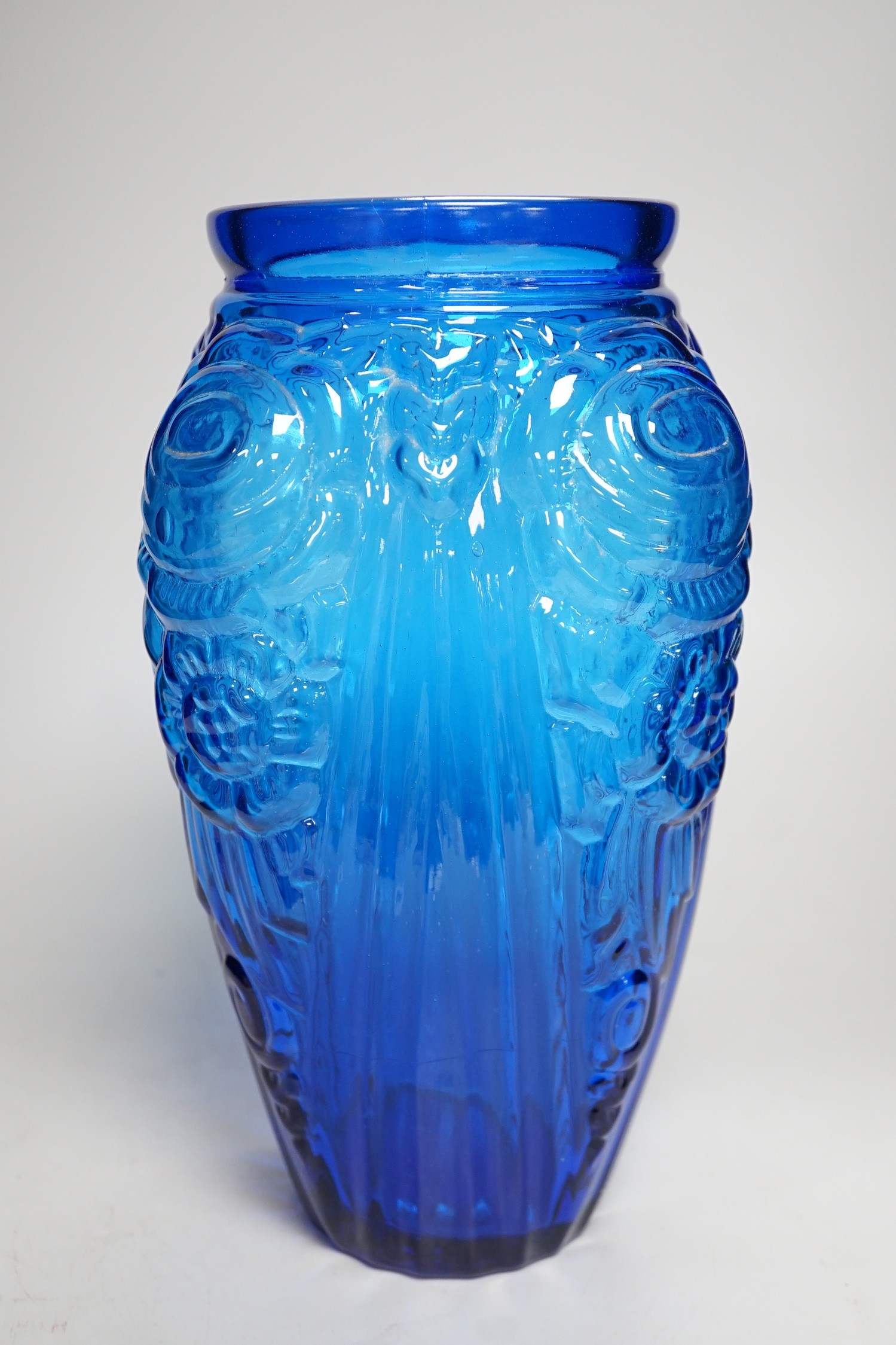 An Art Deco blue floral moulded glass vase. 31cm tall